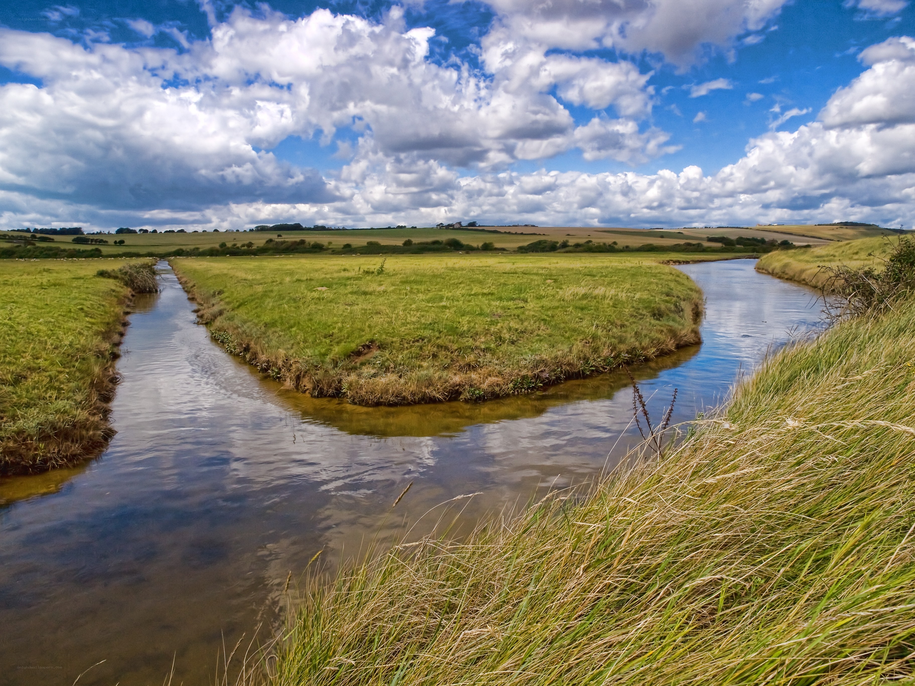 River meandering through green fields