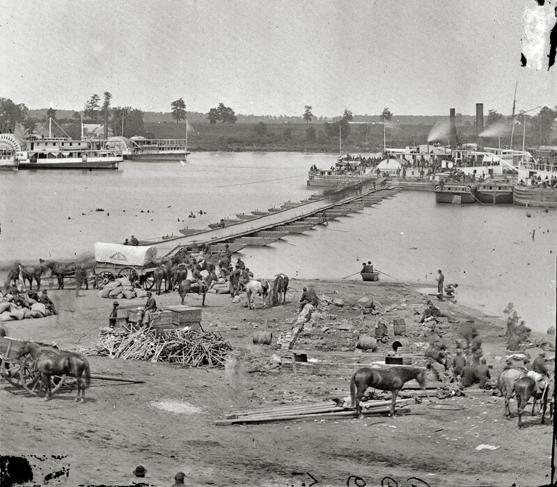 River port with steamboats and wagons