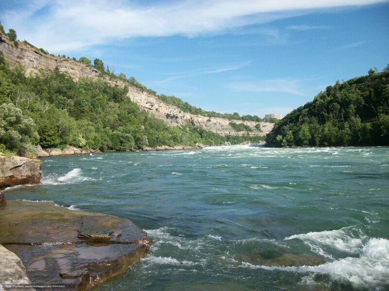 river rapids between cliffs