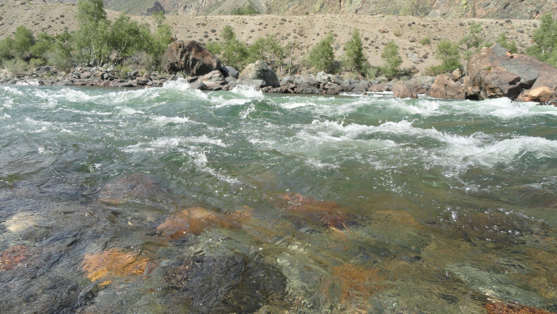 river rapids in mountain valley
