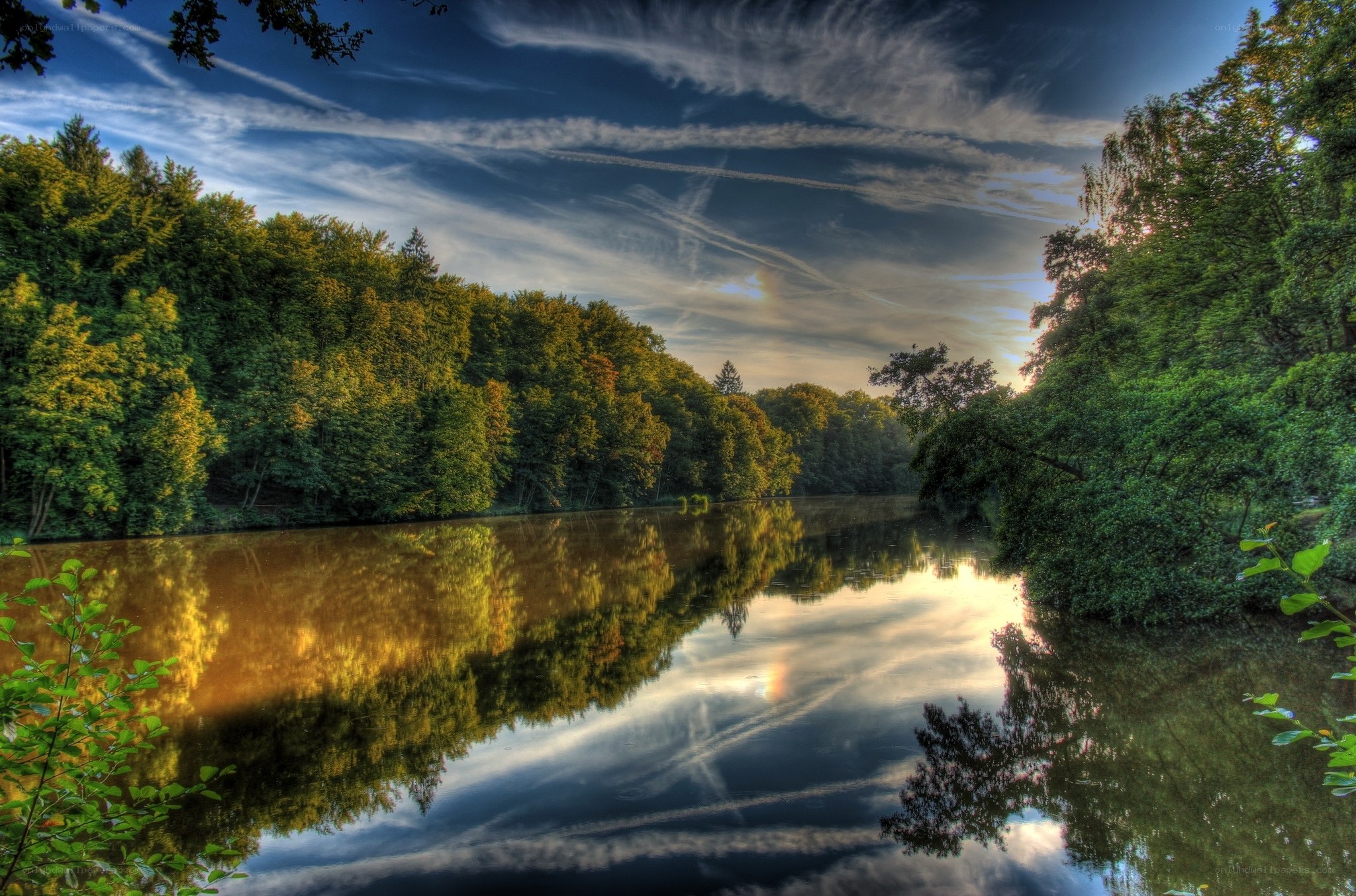 River reflecting forest and sky