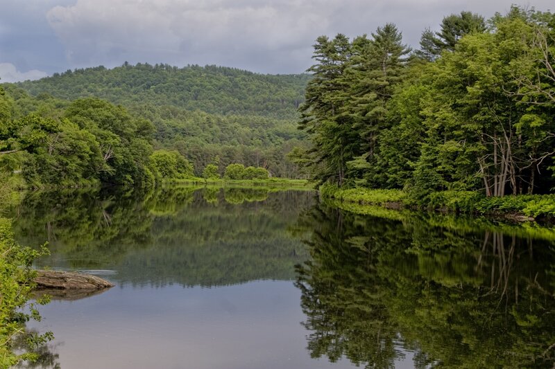 River reflecting forested hills