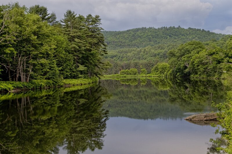 River reflecting forested hills