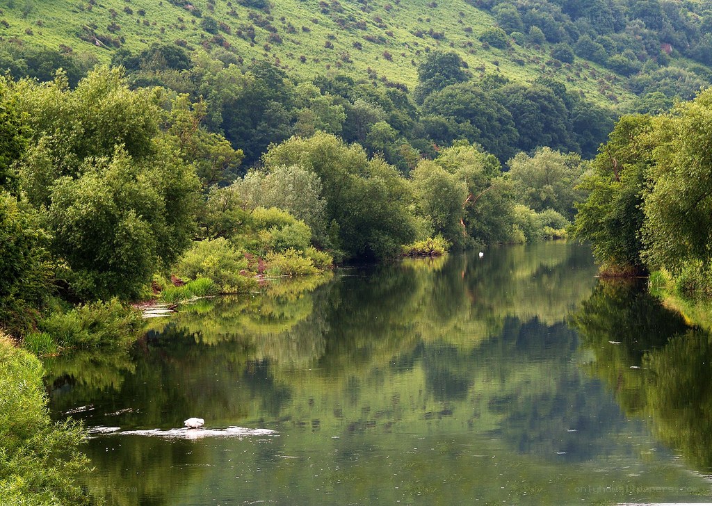River reflecting green hills