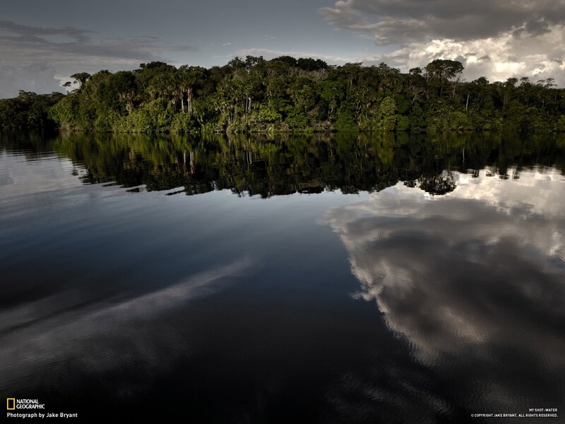 River reflecting jungle and clouds