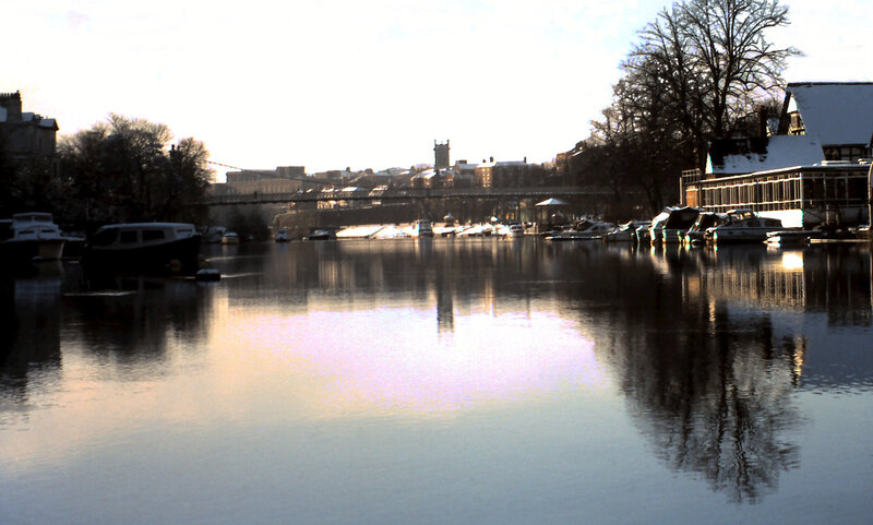 river scene with boats and bridge