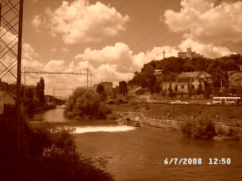 River scene with dam and hillside buildings