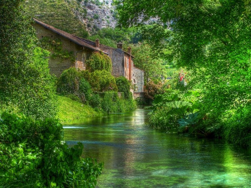 River scene with old house