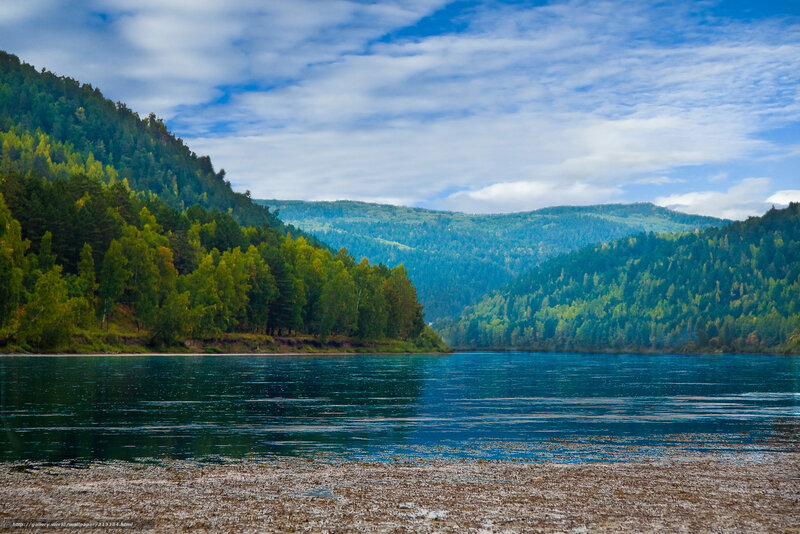 River surrounded by forested hills