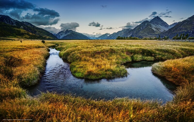 River Through Grassy Field — Blue, Serene, Sunset