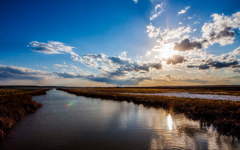 River Through Marshland — Blue, Serene, Sunset