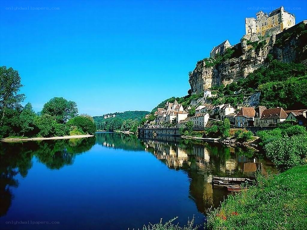 River town with castle on cliff