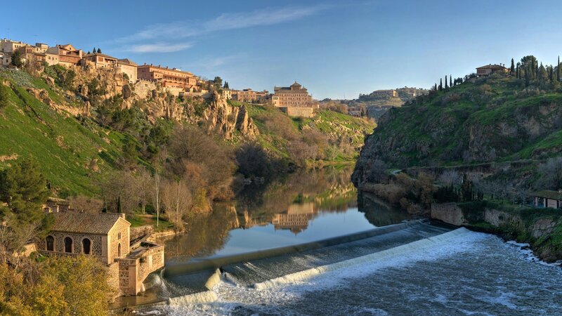 River town with dam and reflection