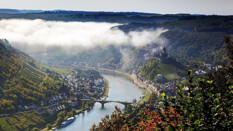 River valley with castle and fog