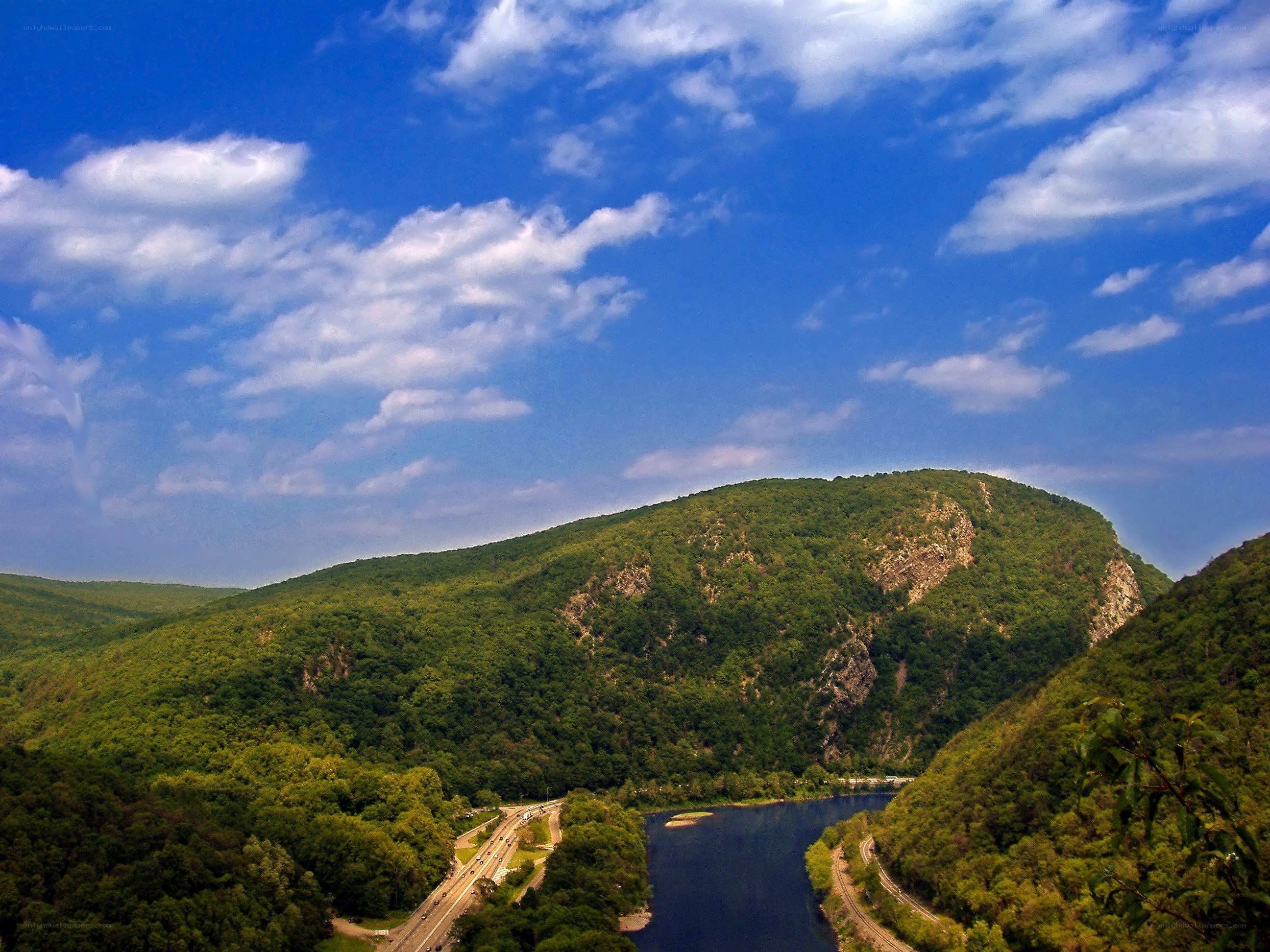 river valley with forested hills