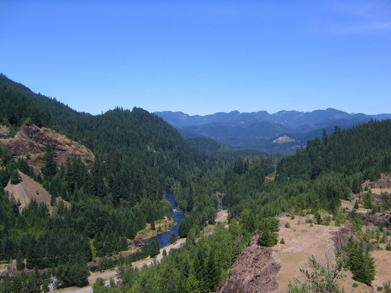 river valley with forested mountains