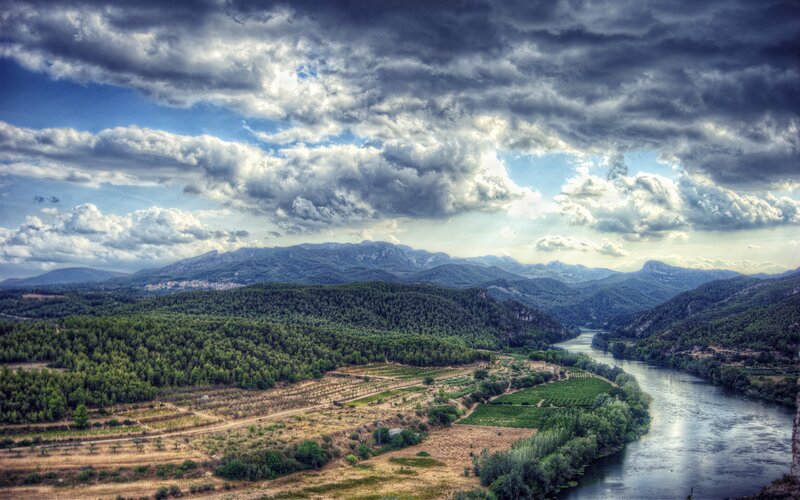 River valley with mountains and clouds