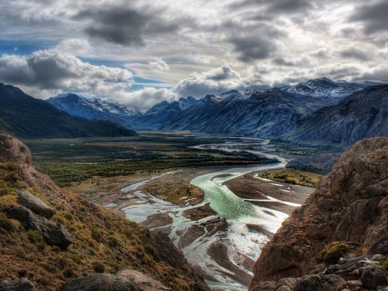 river valley with snow-capped mountains