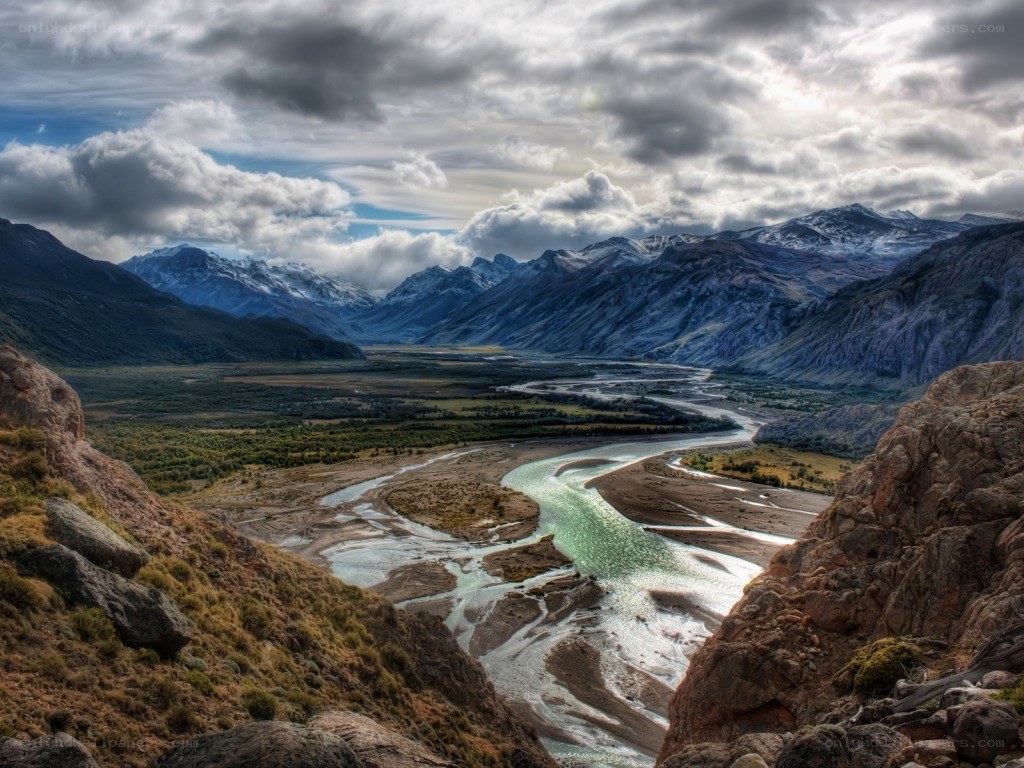 river valley with snow-capped mountains