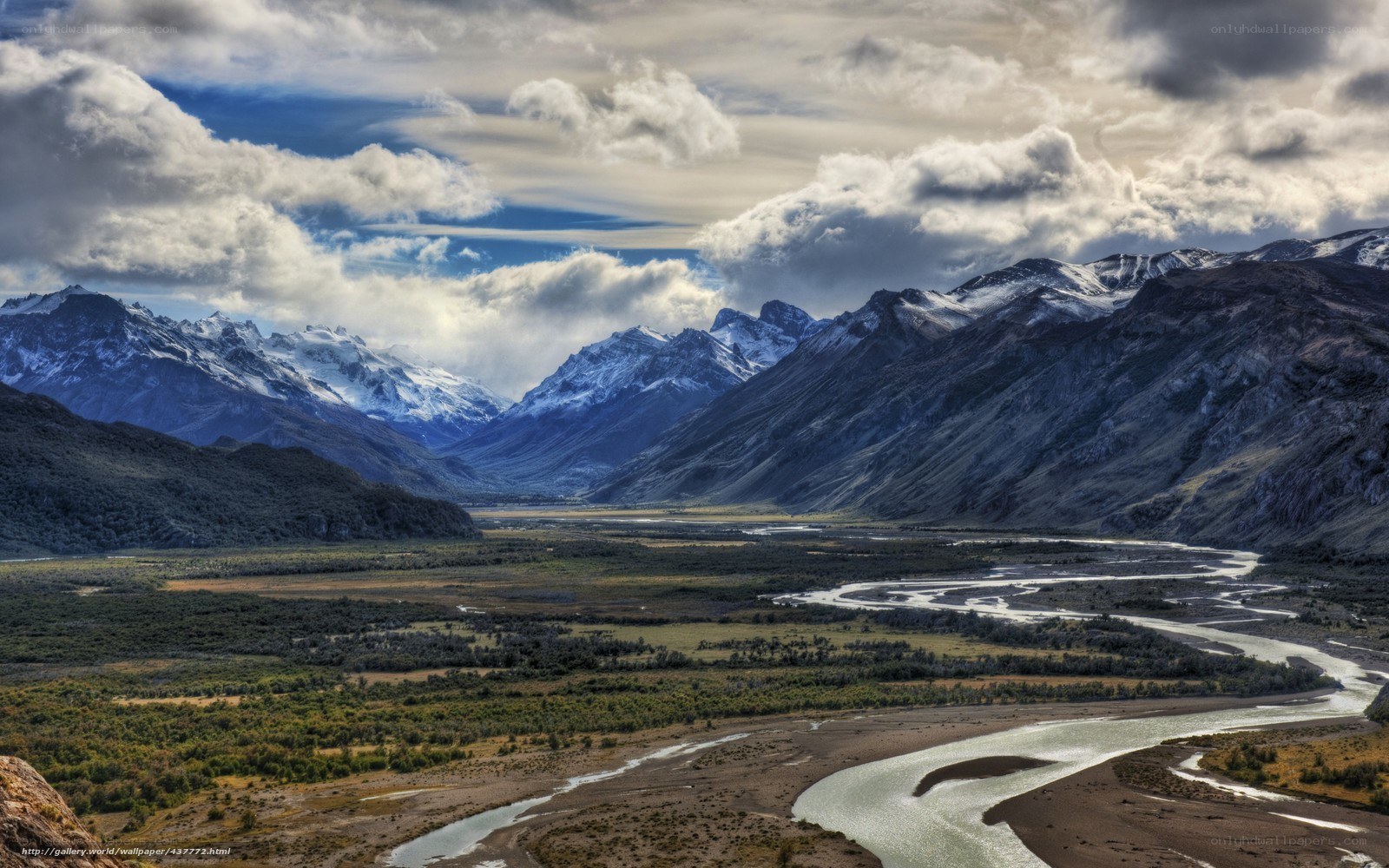 river valley with snow-capped mountains