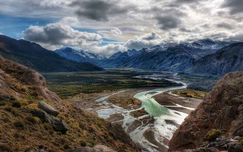 river valley with snow-capped mountains