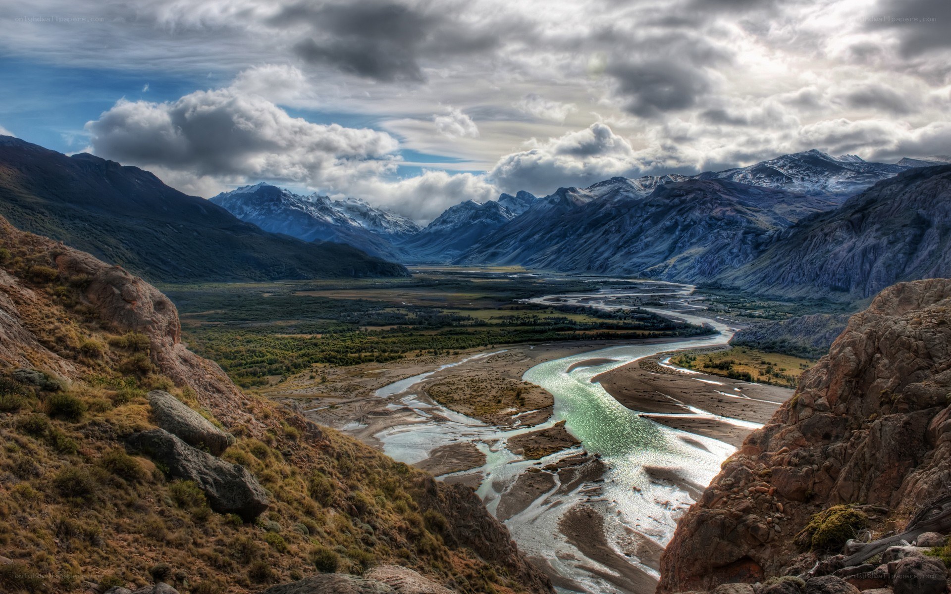 river valley with snow-capped mountains