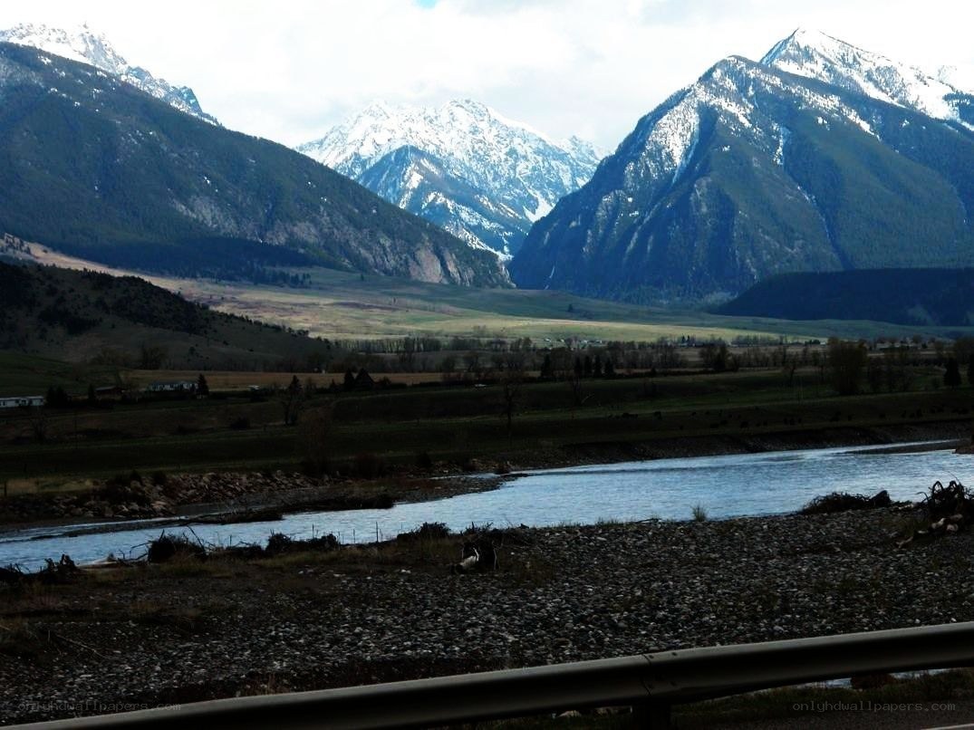 river valley with snow-capped mountains