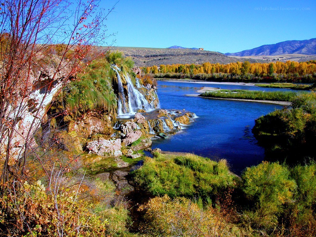 River waterfall in autumn landscape