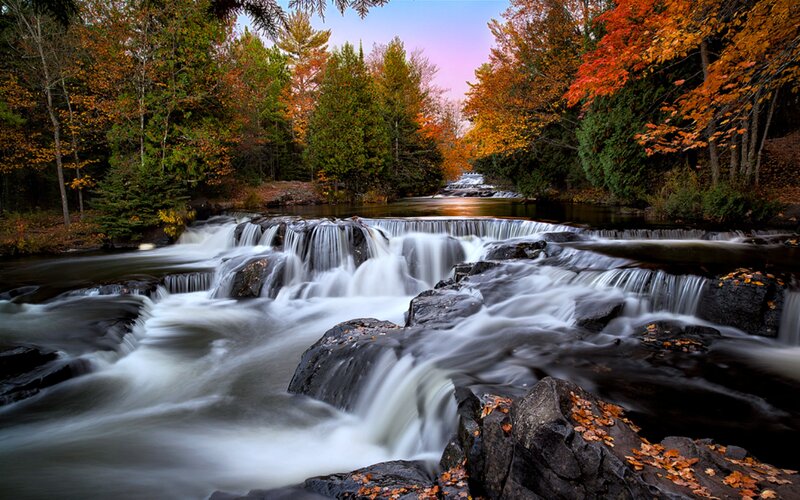 River Waterfall in Forest — Orange, Serene