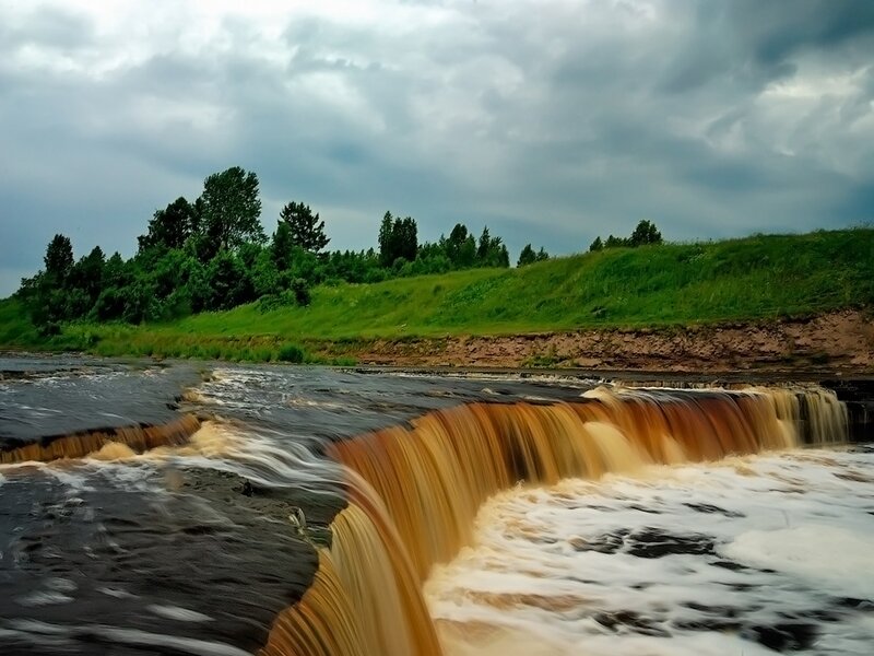 River waterfall under cloudy sky