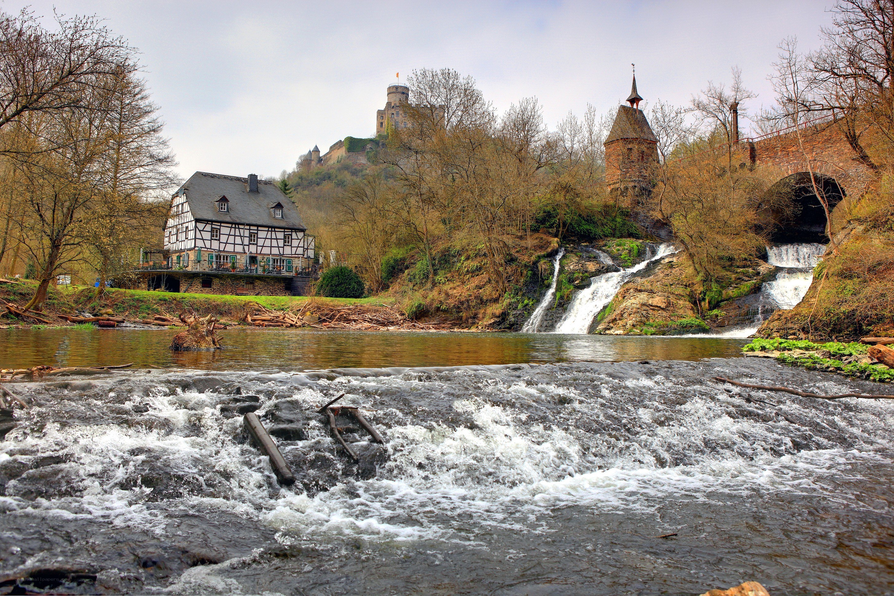 River waterfall with castle in background