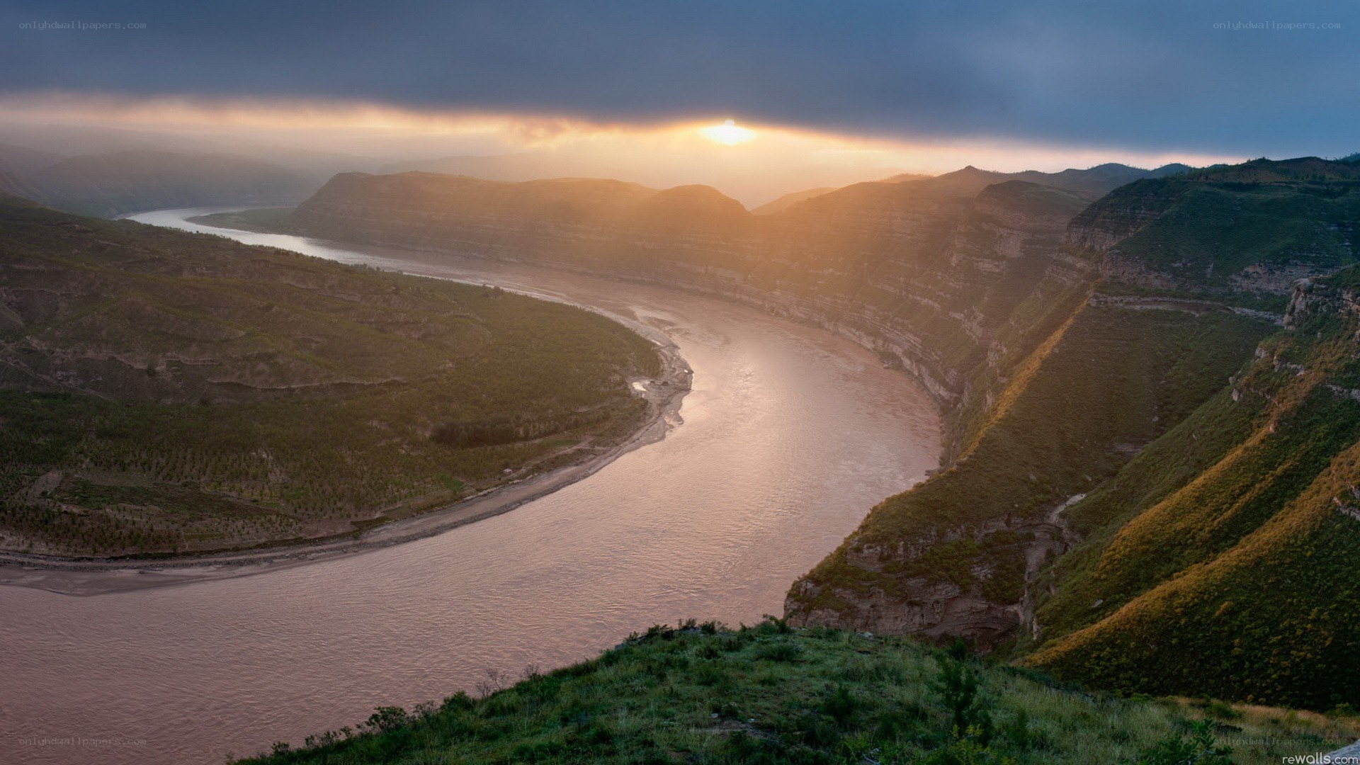river winding through canyon at sunset