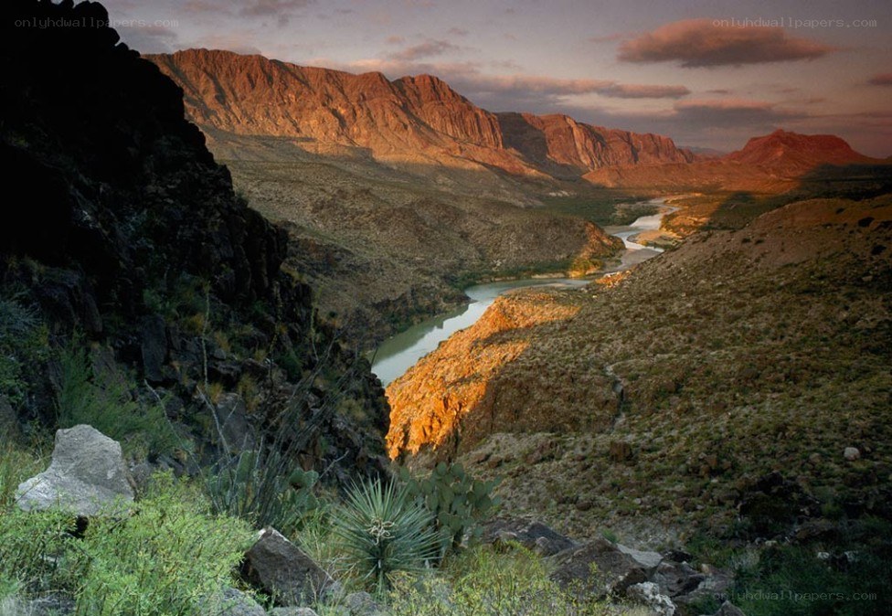 River winding through canyon at sunset