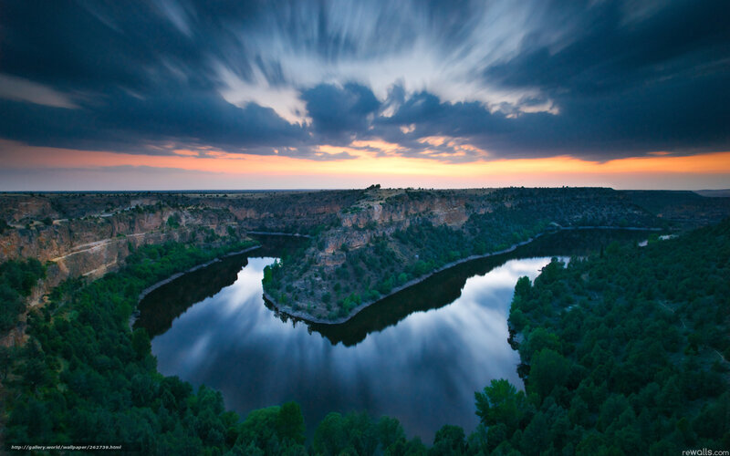 River winding through canyon at sunset