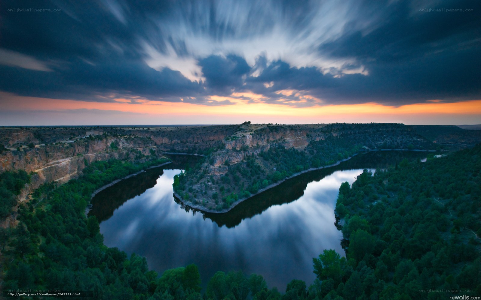 River winding through canyon at sunset