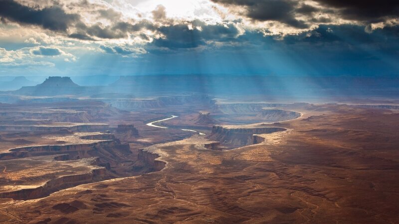 River Winding Through Canyon — Brown, Dramatic, Afternoon, Photograph, Clouds, Sunlight, Blue, White