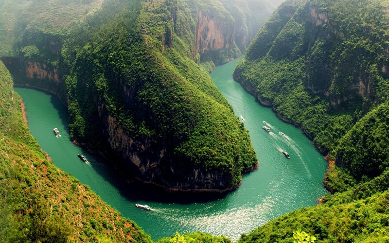 River Winding Through Canyon — Green, Serene, Afternoon, Photograph, Boats