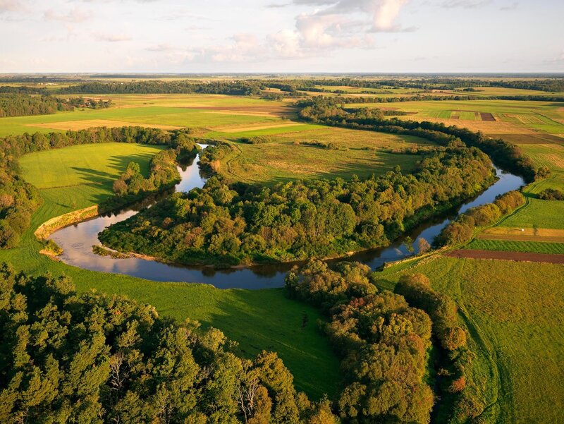 River Winding Through Fields — Green, Serene