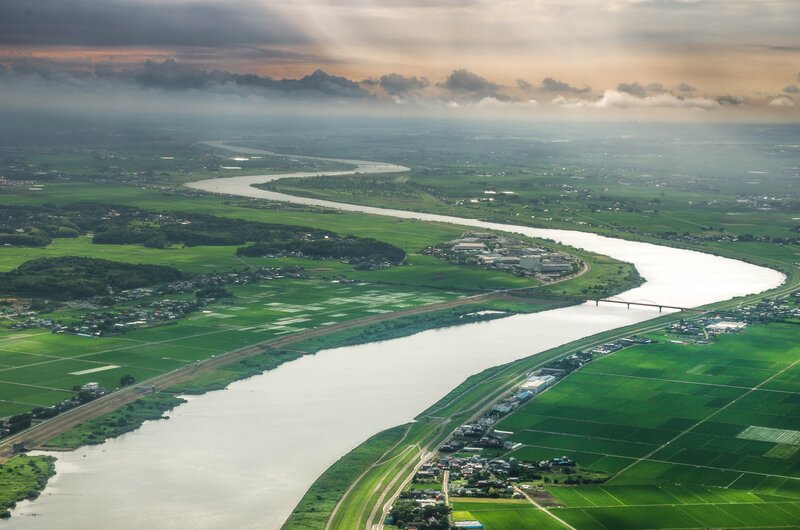 River Winding Through Fields