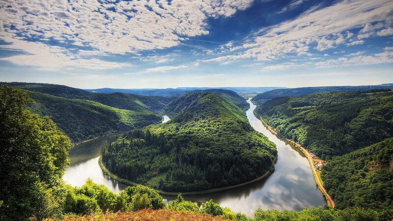 River Winding Through Forest — Green, Serene, Afternoon, Photograph, Hills, Sky, Blue