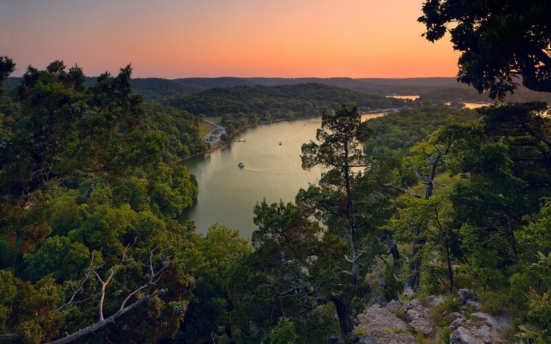 River Winding Through Forest — Green, Serene, Sunset