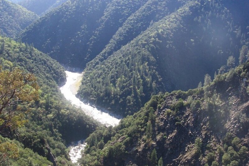 river winding through forested canyon
