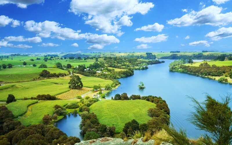 River Winding Through Green Fields — Blue