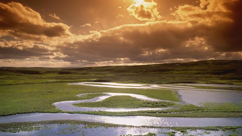 River winding through green plains