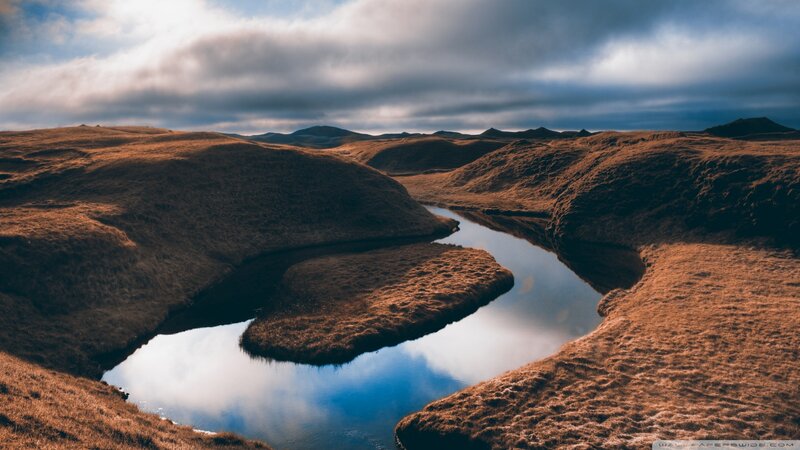 River Winding Through Hills — Brown