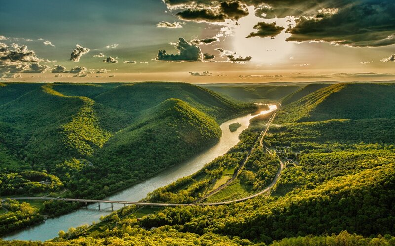 River Winding Through Hills — Green, Dramatic, Sunset