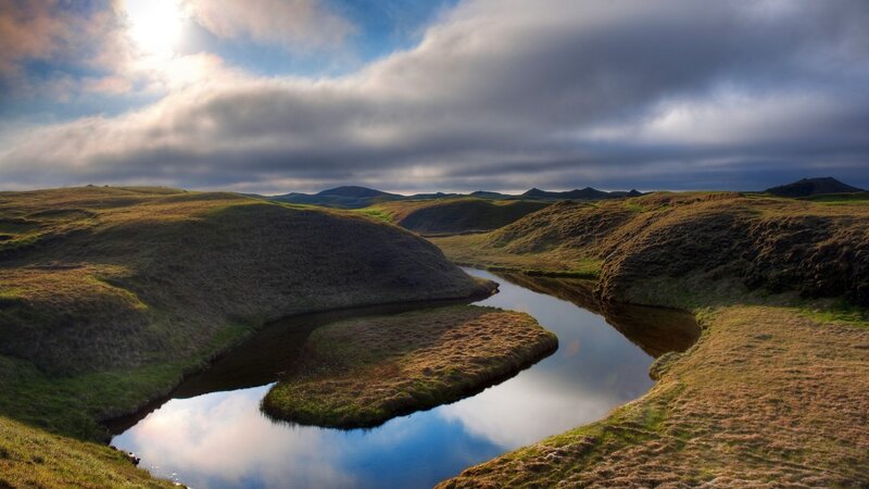 River Winding Through Hills — Green, Serene