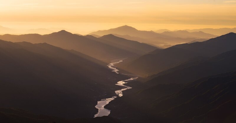 River Winding Through Mountains — Orange, Serene, Sunset, Photograph
