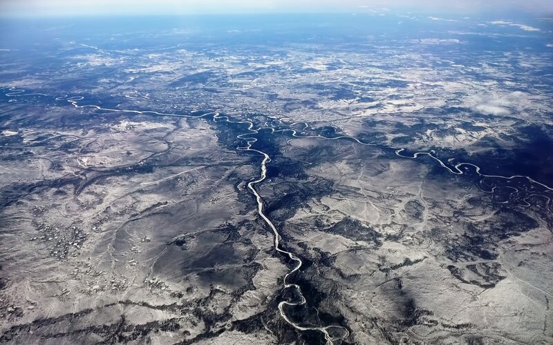 River Winding Through Terrain