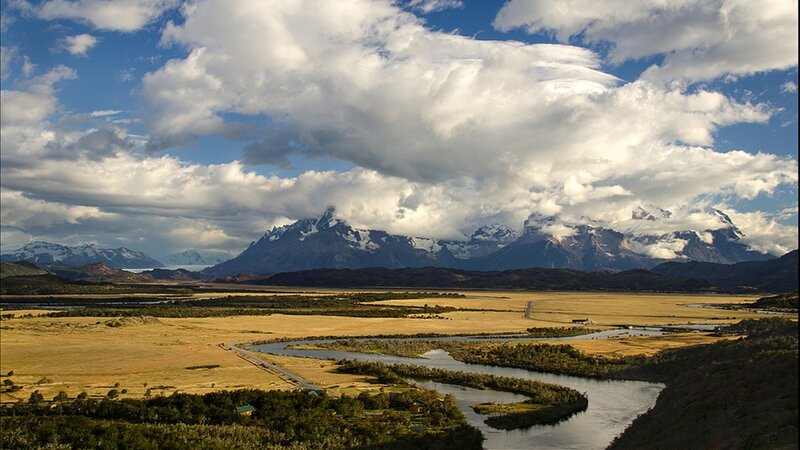 River Winding Through Valley — Blue, Dramatic, Afternoon, Photograph, Mountains, Clouds, Grassland